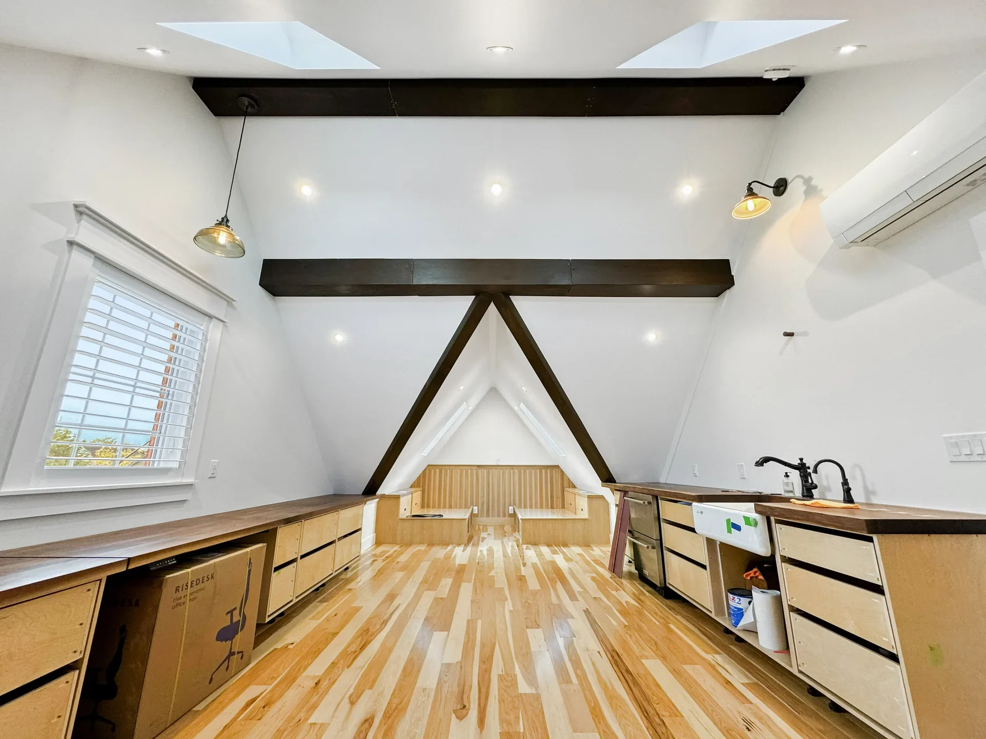Finished attic conversion with exposed beams and built-in cabinetry