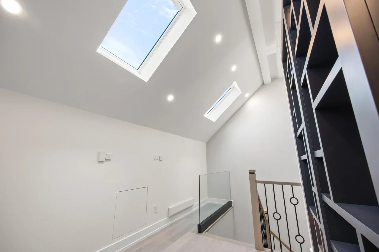 Finished attic stair landing with skylights and built-in storage