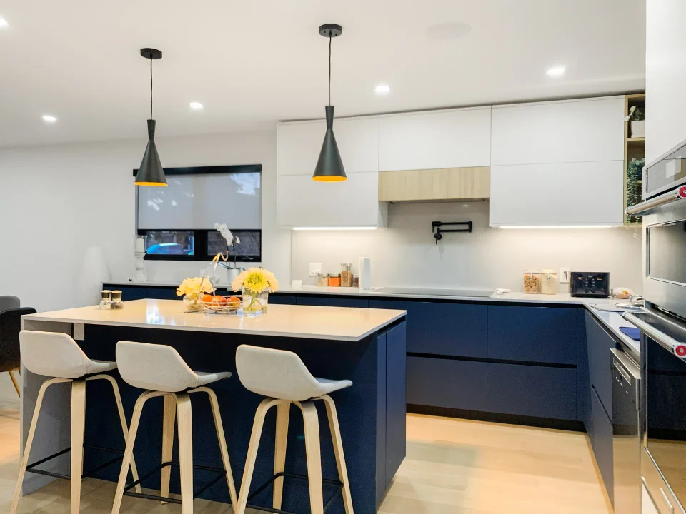 Finished kitchen with blue island and modern white cabinetry
